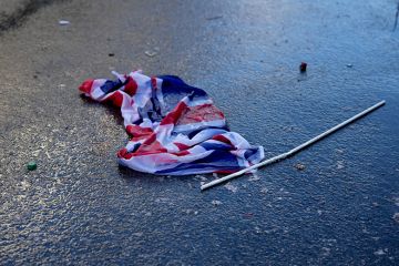 A Union Jack flag is seen discarded on the ground, to illustrate Whitehall cuts ‘undermining’ international education expansion.