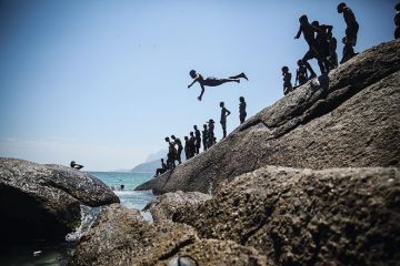 Boy diving into ocean