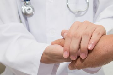 Making it personal Doctor holding hands with patient