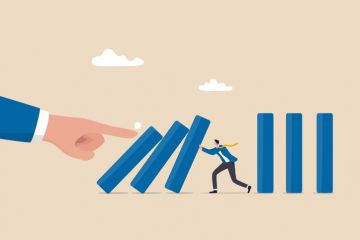 Illustration: a businessman tries to stop a line of falling dominoes, being pushed over by a giant hand Illustration: a businessman tries to stop a line of falling dominoes, being pushed over by a giant hand