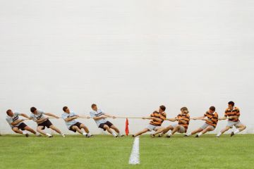 Eight men in tug of war battle