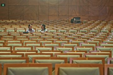 Two women in empty lecture hall