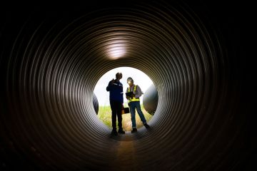 Engineers looking down a dark tunnel at an infrastructure project. To illustrate that degree apprenticeships are ‘under threat’ as more courses are defunded.