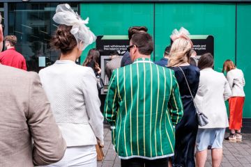 Line Of Men And Women Queuing To Withdraw Money From An ATM Cash Point Machine Epsom Surrey, London UK, June 04 2022, Line Of Men And Women Queuing To Withdraw Money From An ATM Cash Point Machine