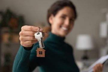 An estate agent holds up house keys