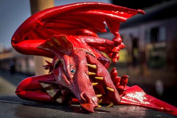 A fallen red Welsh dragon, illustrating whether the regulator Medr can find its teeth and reshape the Welsh university sector.