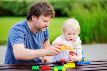 Father and child playing with blocks