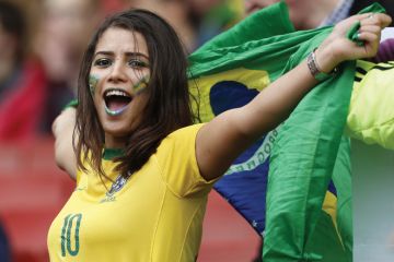Female Brazilian football/soccer fan celebrating with flag of Brazil, Best universities in Latin America