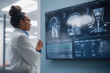 A female doctor looks at an MRI image