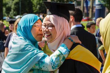 Female international student is congratulated at a university graduation, Keele University Female international student is congratulated at a university graduation, Keele University