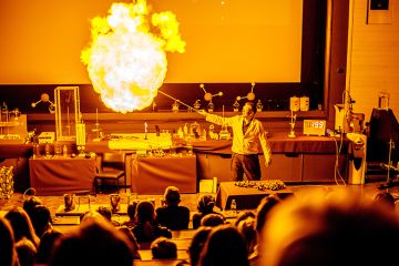 A lecturer with a fireball at the Cambridge Science Festival. To illustrate the precarity of teaching-only and temporary roles in universities as they bear the brunt of the UK jobs cull.