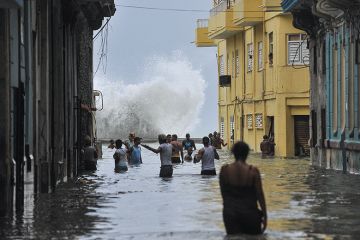 Cubans wade through a flooded street in Havana after Hurricane Irma swept through the country in 2017 Cubans wade through a flooded street in Havana after Hurricane Irma swept through the country in 2017
