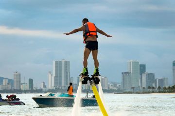 Man on a flyboard (aerial machine for personal watercraft) in Vietnam. To illustrate Vietnam’s new wave of ambitious universities. Man on a flyboard (aerial machine for personal watercraft) in Vietnam. To illustrate Vietnam’s new wave of ambitious universities.