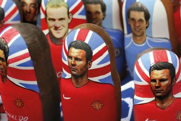 Portraits of Manchester United footballers Wayne Rooney, Cristiano Ronaldo and Ryan Giggs on traditional Russian “matreshka” nesting dolls in Moscow