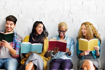 Four people sitting in a row reading books Four people sitting in a row reading books