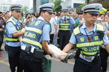Gao kao exam in China. Policemen rescue woman who fainted Gao kao exam in China. Policemen rescue woman who fainted
