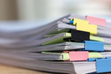 A stack of papers with colourful paper clips