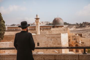 A Jewish man looking at the wailing wall in Jerusalem,Israel. A Jewish man looking at the wailing wall in Jerusalem,Israel.