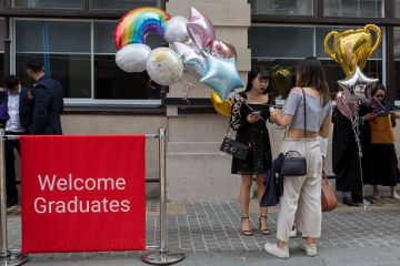 Friends and family of Hillary Chung, a 21 year-old Law graduate from Hong Kong, celebrate her graduation with a 2:1 degree outside the London School of Economics
