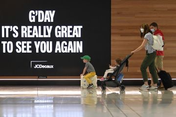 A family leave to board a plane at Sydney's International Airport A family leave to board a plane at Sydney's International Airport