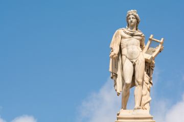 The statue of Apollo in Athens against the blue sky