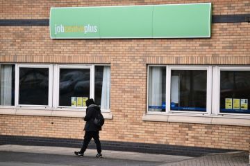 A man walks past a Jobcentre Plus employment office A man walks past a Jobcentre Plus employment office