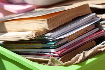  Lots of different old books and paper notebooks in a container