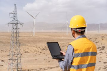 Male engineer is working in wind power station Male engineer is working in wind power station