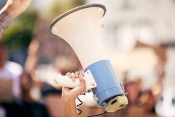 a protester holding a megaphone during a rally a protester holding a megaphone during a rally