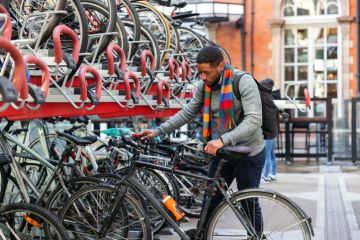 Student Parking His Bike In The City Student Parking His Bike In The City
