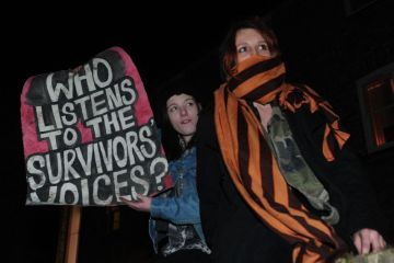 Protesters hold a placard at Cambridge University Union Protesters hold a placard at Cambridge University Union