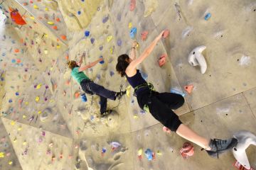 Young sporty climbers on a climbing wall Young sporty climbers on a climbing wall