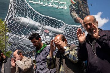 Iranians gather in Tehran's Revolution Square after the United States and Iran agreed to a two-week ceasefire
