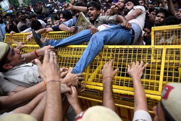 Activists and supporters of the Cockroach Janta Party (CJP) clash with police personnel during a protest demanding the resignation of India's education minister Dharmendra Pradhan Activists and supporters of the Cockroach Janta Party (CJP) clash with police personnel during a protest demanding the resignation of India's education minister Dharmendra Pradhan