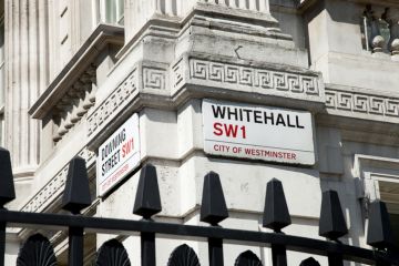 Street signs on the corner of Downing Street and Whitehall.