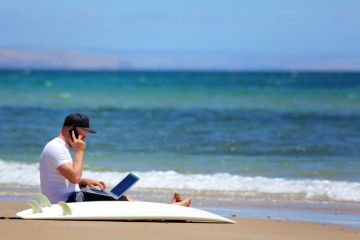 A man working when he should be surfing A man working when he should be surfing
