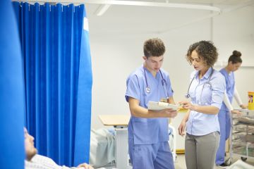Male and female doctors on the hospital ward Male and female doctors on the hospital ward