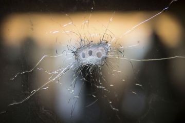 Glass with bullet holes Glass with bullet holes