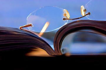 Glasses lying on top of a journal
