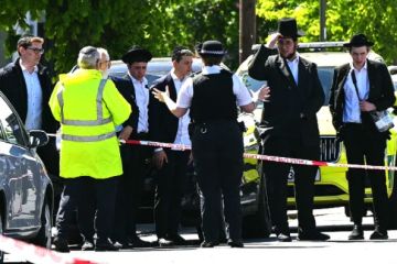  Local residents look on from outside a cordoned off area in the Golders Green neighbourhood of north London on April 29 following the stabbing to two people nearby. 