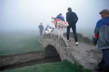 Golfers crossing a bridge in fog Golfers crossing a bridge in fog