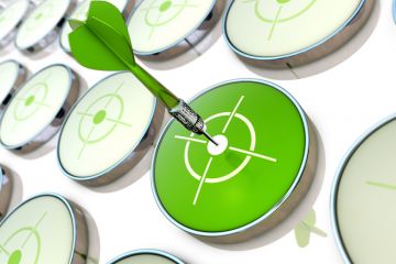 A green dart hits a target