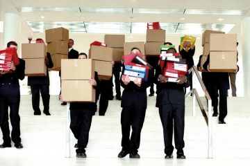 Group of businessmen carrying boxes from office Group of businessmen carrying boxes from office