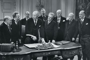 Group of old men signing paperwork Group of old men signing paperwork