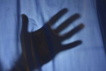 Hand behind sheet