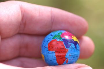 Hand holding globe showing Africa