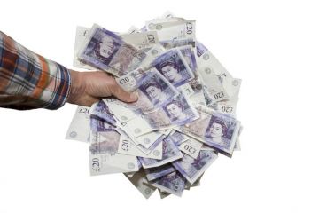 Hand holding £20 notes Hand holding £20 notes