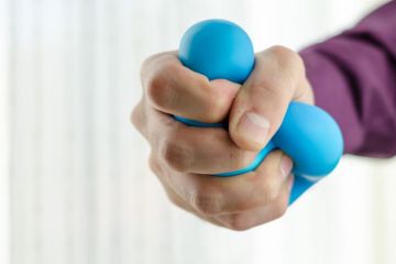 Hand squeezing stress ball Hand squeezing stress ball
