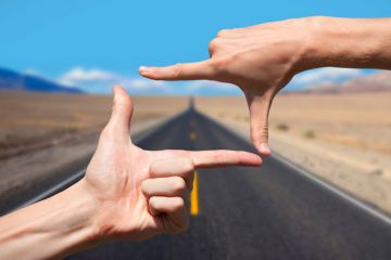 Hands composing photograph of road ahead Hands composing photograph of road ahead