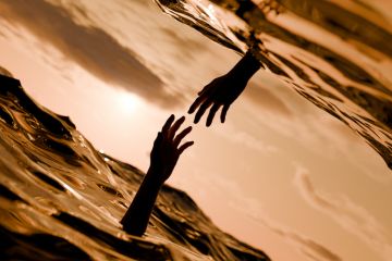 Two hands reach out of the water to each other, symbolising mutual support Two hands reach out of the water to each other, symbolising mutual support